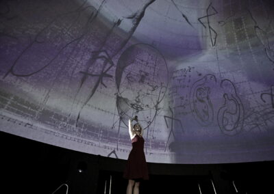 human being and art figure in a dome-theatre