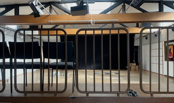 View across the tribune railing into the rehearsal studio